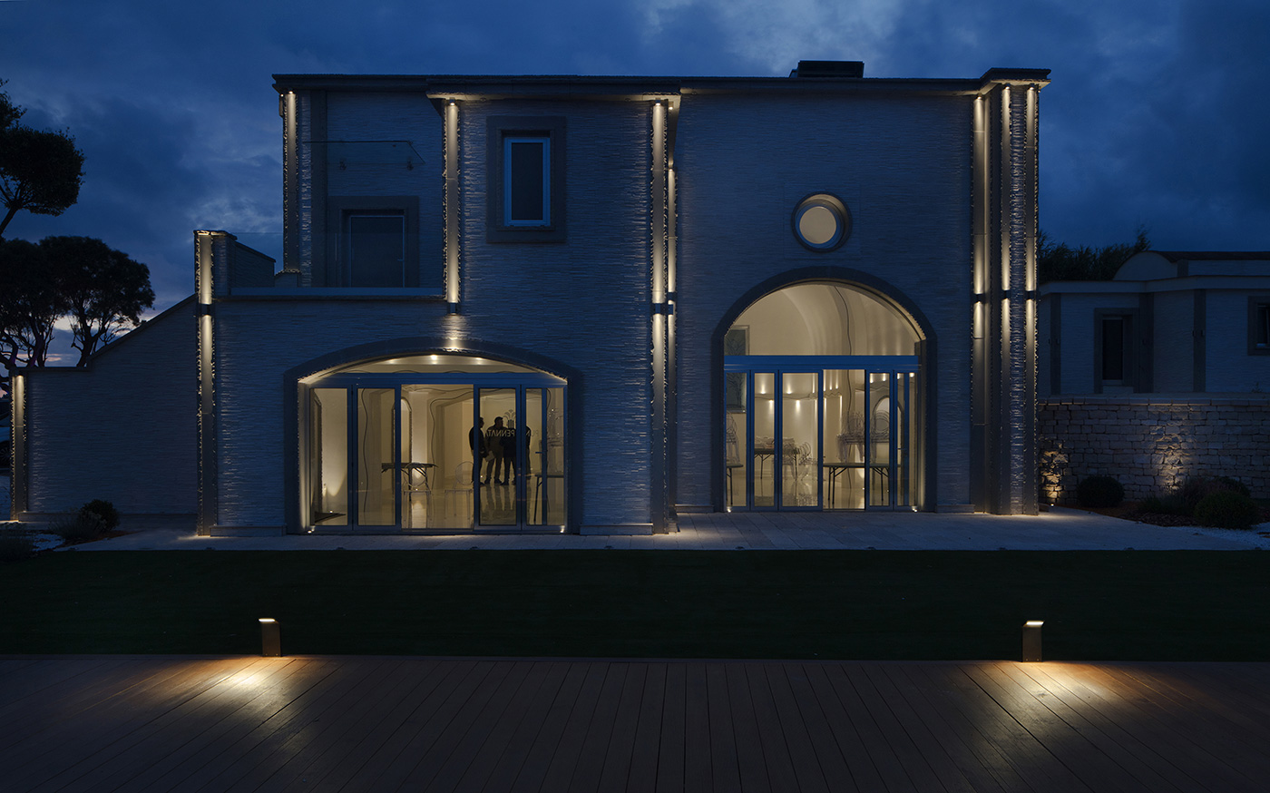 Villa Punta Pennata in Bacoli uses light to make its facade legible after dusk.